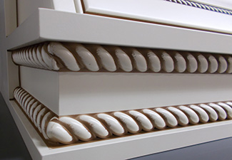 Image showing white painted applied rope molding on a range hood with mocha glaze
