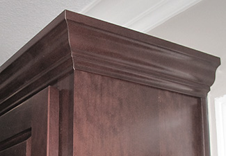 Image showing upper cabinet with dark stained wood crown molding