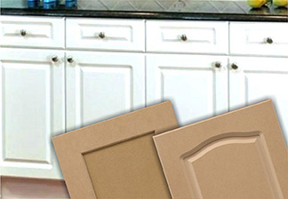Image of lower cabinets with 1-piece white painted cabinet doors and drawer fronts and 2 close up raw routered HDF doors angled in front