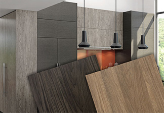 Picture of medium and dark grey Laminate Slab kitchen with two close up angled TFL cabinet doors in alternate finishes in front