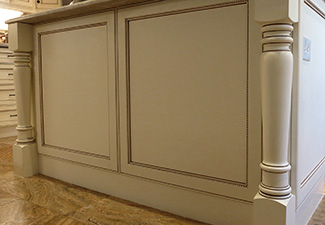 Image of custom wood painted and glazed island cabinet posts