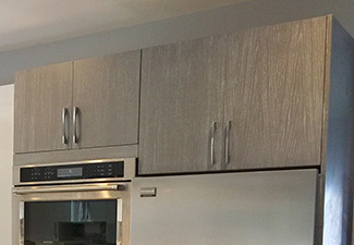 Image showing a partial kitchen image showing grey stained wood slab doors
